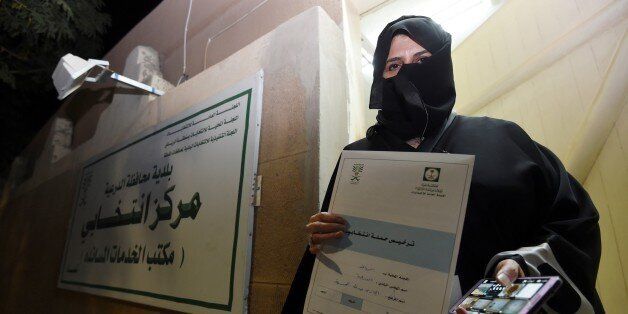 Aljazi al-Hussaini, a candidate for the municipal council in the town of Diriyah, on the outskirts of the Saudi capital Riyadh, shows an electoral campaign license issued by the central municipal elections committee on November 29, 2015. Women in Saudi Arabia begin their first-ever electoral campaign on November 29, a step forward for both womens rights and the kingdoms slow democratic process. Hundreds of Saudi women began campaigning for public office, in a first for women in the conservative Muslim kingdom's slow reform process even as two activists were disqualified. AFP PHOTO / FAYEZ NURELDINE / AFP / FAYEZ NURELDINE (Photo credit should read FAYEZ NURELDINE/AFP/Getty Images)