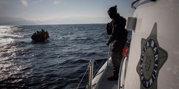 Members of the Frontex, European Border Protection Agency, from Portugal approach a dingy with 56 people, who were lost in an open sea as they try to get to the Greek island of Lesbos, Tuesday, Dec. 8, 2015. In another incident six children have drowned after a rubber dinghy carrying Afghan migrants to Greece sank off Turkey's Aegean coast. Turkey has stepped up efforts to stop migrants from leaving to Greece by sea. (AP Photo/Santi Palacios)