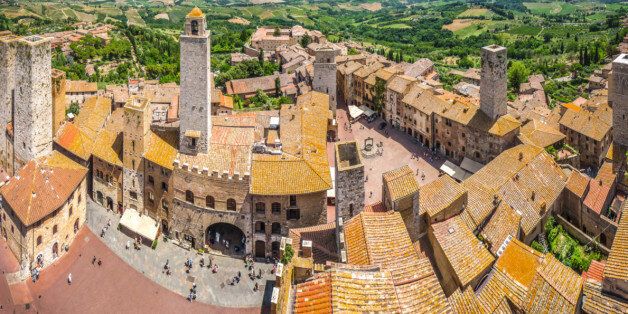 Aerial wide-angle view of the historic town of San Gimignano with tuscan countryside on a sunny day, Tuscany, Italy