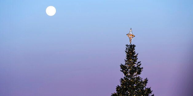 CENTENNIAL, CO - DECEMBER 18: A full moon is seen over a Christmas tree in Centennial Center Park, December 18, 2013. Forecast are calling for temperatures in the mid 60s for the area. (Photo by RJ Sangosti/The Denver Post via Getty Images)
