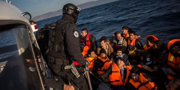 Members of the Frontex, European Border Protection Agency, from Portugal rescue 56 people, who were lost in an open sea as they try to approach on a dinghy the Greek island of Lesbos, Tuesday, Dec. 8, 2015. In another incident six children drowned after a rubber dinghy carrying Afghan migrants to Greece sank off Turkey's Aegean coast. Turkey has stepped up efforts to stop migrants from leaving to Greece by sea. (AP Photo/Santi Palacios)
