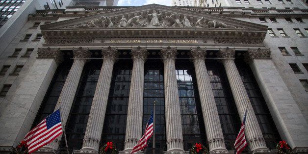 American flags wave on the exterior of the New York Stock Exchange (NYSE) in New York, U.S., on Wednesday, Dec. 16, 2015. The Federal Reserve raised interest rates for the first time in almost a decade in a widely telegraphed move while signaling that the pace of subsequent increases will be 'gradual' and in line with previous projections. Photographer: Michael Nagle/Bloomberg via Getty Images