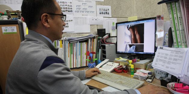 In this Nov. 20, 2012 photo, Moon Tae-hwa, a devout Christian and family counselor, uses a desktop computer to hunt down online pornography at his office in Seoul, South Korea. Moon is among the most successful members of the âNuri Copsâ (roughly ânet copsâ), a squad of nearly 800 volunteers who help government censors by patrolling the Internet for pornography in their spare time. (AP Photo/Ahn Young-joon)