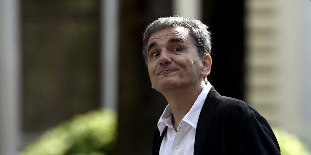 Greek Finance Minister Euclides Tsakalotos grimaces as he leaves the presidential palace after the swearing-in ceremony of the new government in Athens on September 23, 2015. Greek Prime Minister Alexis Tsipras took office with a core of returning ministers pledging to restart the country's flagging economy. AFP PHOTO / ARIS MESSINIS (Photo credit should read ARIS MESSINIS/AFP/Getty Images)