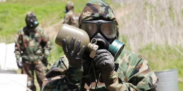 A U.S. Army soldier drinks waters during a CBR (chemical, biological and radiological) warfare training exercise at Yeoncheon near the border with North Korea, in South Korea, Thursday, May 16, 2013. The military exercise, held between South Korea and the U.S., is meant to affirm and improve their joint management system. (AP Photo/Ahnn Young-joon)