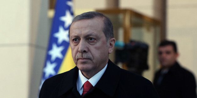 Turkish President Recep Tayyip Erdogan walks before a welcoming ceremony for Chairman of Bosnian tripartite Presidency Dragan Covic in Ankara, Turkey, Thursday, Dec. 10, 2015.(AP Photo/Burhan Ozbilici)