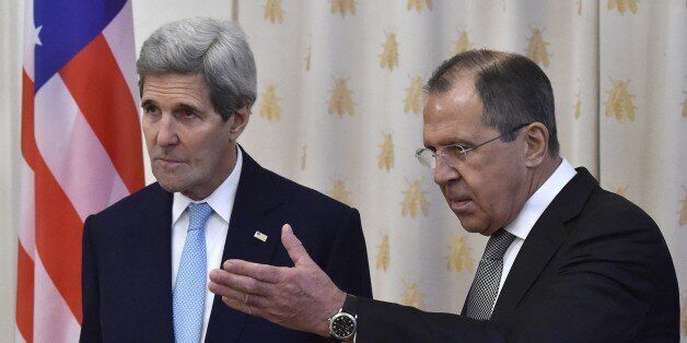 Russian Foreign Minister Sergei Lavrov (R) shows the way to US Secretary of State John Kerry during their meeting in Moscow on December 15, 2015. AFP PHOTO / YURI KADOBNOV / AFP / YURI KADOBNOV (Photo credit should read YURI KADOBNOV/AFP/Getty Images)