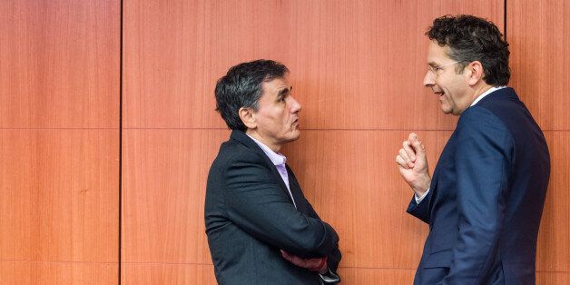 Greece's Finance Minister Euclid Tsakalotos, left, talks with Dutch Finance Minister and chair of the eurogroup of finance ministers, Jeroen Dijsselbloem, during a Eurogroup finance ministers meeting at the EU Council building in Brussels Monday, Dec. 7, 2015. (AP Photo/Geert Vanden Wijngaert)