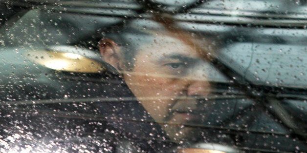 Greek Prime Minister Alexis Tsipras looks out of his car window as he arrives for an EU-Turkey summit at the EU Council building in Brussels on Sunday, Nov. 29, 2015. At a high-profile summit in Brussels on Sunday, European Union leaders will look to offer Turkey 3 billion euros ($3.2 billion), an easing of visa restrictions and the fast-tracking of its EU membership process in return for tightening border security and take back some migrants who don't qualify for asylum. (AP Photo/Francois Walschaerts)