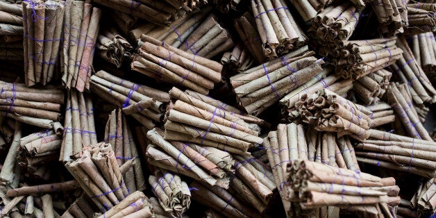 Bundles of bidi cigarettes sit at the Sarkar Bidi Factory in Kannauj, Uttar Pradesh, India, on Wednesday, June 3, 2015. India's smokers are favoring cheaper options such as chewing and leaf-wrapped tobacco over cigarettes, as rising taxes prompt British American Tobacco Plc's Indian associate ITC Ltd. to sell shorter sticks with lower duties. Photographer: Udit Kulshrestha/Bloomberg via Getty Images