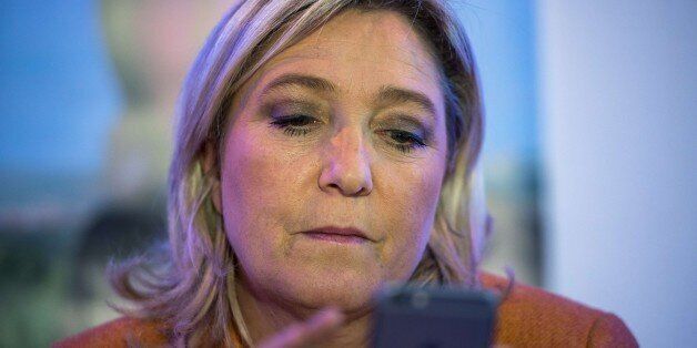 French far-right Front National (FN)'s president and candidate for the regional elections in Nord-Pas-de-Calais-Picardie, Marine le Pen looks at her phone during a press conference on October 2, 2015 in Calais, northern France. AFP PHOTO / PHILIPPE HUGUEN (Photo credit should read PHILIPPE HUGUEN/AFP/Getty Images)