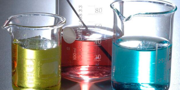 Three beakers of colorful chemicals in a row, with bright light shining through, Red blue and yellow colored liquids are in different sized glass jars (Photo by: Digital Light Source/UIG via Getty Images)