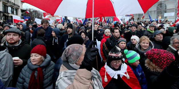 Tens of thousands of Poles angered by an ongoing constitutional conflict march in Warsaw, Poland on Saturday, Dec. 12, 2015, to protest against the role that President Andrzej Duda and the new conservative government have had in the swelling discord. (AP Photo/Czarek Sokolowski)