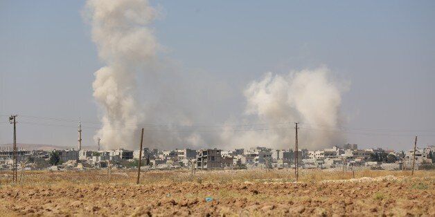 SANLIURFA, TURKEY - JUNE 27: A view of the Syrian border town of Kobani (Ayn al-Arab) from the borderline between Turkey and Syria in Sanliurfa province on June 27, 2015 during the clashes between Daesh militants and and Kurdish armed groups. (Photo by Esber Ayaydin/Anadolu Agency/Getty Images)