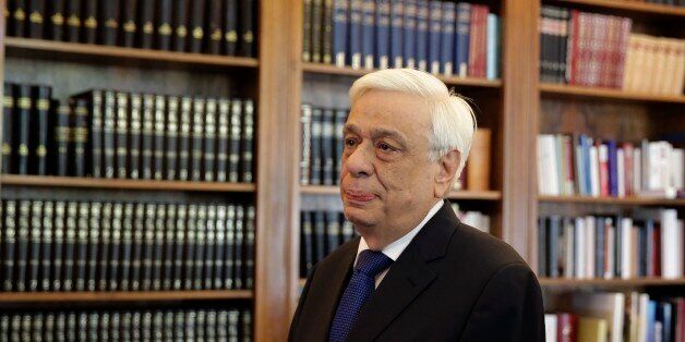 Greek President Prokopis Pavlopoulos, waits the arrival of former Energy Minister and head a party called Popular Unity , Panagiotis Lafazanis, before their meeting in Athens, Thursday, Aug. 27, 2015. Greece came one step closer to early elections Thursday as Lafazanis the head of a new breakaway left-wing party returned his mandate to form a government to the country's president after having failed to find willing coalition partners.(AP Photo/Petros Giannakouris)