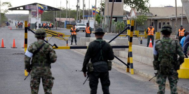 Colombian police officers and soldiers patrol the border between Colombia and Venezuela, in Paraguachon, Colombia, Wednesday, Sept. 9, 2015. Venezuelan President Nicolas Maduro has expanded an anti-smuggling offensive along the country's frontier with Colombia, and ordered another main crossing, this one in Paraguachon, closed Monday night as part of a two-week-old anti-smuggling offensive. (AP Photo/Fernando Vergara)