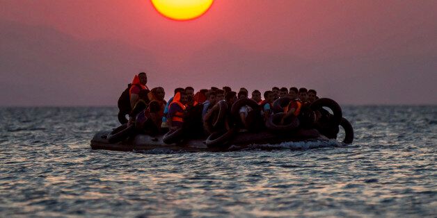 FOR USE AS DESIRED, YEAR END PHOTOS - FILE - Migrants on a dinghy arrives at the southeastern island of Kos, Greece, after crossing from Turkey, Thursday, Aug. 13, 2015. Greece has become the main gateway to Europe for tens of thousands of refugees and economic migrants, mainly Syrians fleeing war, as fighting in Libya has made the alternative route from north Africa to Italy increasingly dangerous. (AP Photo/Alexander Zemlianichenko, File)