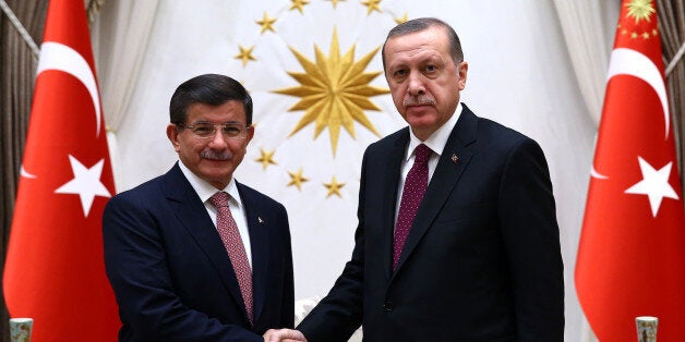 Turkey's Prime Minister Ahmet Davutoglu left, and President Recep Tayyip Erdogan shake hands before a meeting in Ankara, Turkey, Tuesday, Nov. 17, 2015. Erdogan has re-appointed Davutoglu to form a new government after his party's victory in elections on Nov.1.(Presidential Press Service/Pool Photo via AP)