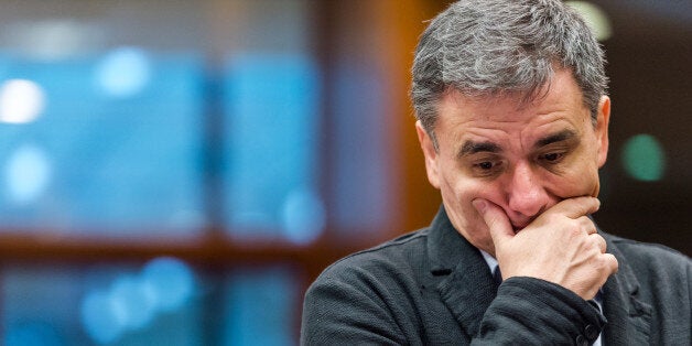 Greek Finance Minister Euclid Tsakalotos arrives for an EU finance ministers meeting at the EU Council building in Brussels on Tuesday, Nov. 10, 2015. (AP Photo/Geert Vanden Wijngaert)