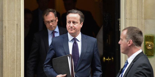 British Prime Minister David Cameron (C) leaves 10 Downing Street in central London on November 26, 2015, bound for the Houses of Parliament where he made a statement to back joining international action against Islamic State jihadists following the November 13 attacks in Paris, which killed 130 people. Cameron said that it was in Britain's national security interests to strike IS jihadists and deny them a 'safe haven' in Syria, arguing that the burden should not fall only on Britain's allies. AFP PHOTO / LEON NEAL / AFP / LEON NEAL (Photo credit should read LEON NEAL/AFP/Getty Images)