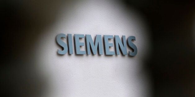 The logo of German industrial conglomerate Siemens is pictured outside their headquarters in Munich, southern Germany, Wednesday, July 31, 2013. Siemens AG has appointed longtime finance chief Joe Kaeser as its new chief executive, replacing Peter Loescher after a series of missed profit targets at the German industrial conglomerate. Siemens said its supervisory board unanimously chose the 56-year-old Kaeser on Wednesday. (AP Photo/Matthias Schrader)