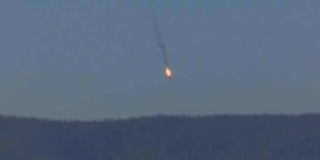 This frame grab from video by Haberturk TV, shows a Russian warplane on fire before crashing on a hill as seen from Hatay province, Turkey, Tuesday, Nov. 24, 2015. Turkey shot down the Russian warplane Tuesday, claiming it had violated Turkish airspace and ignored repeated warnings. Russia denied that the plane crossed the Syrian border into Turkish skies. (Haberturk TV via AP) TURKEY OUT