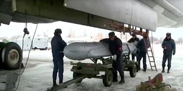 In this photo made from video released by Russian Defense Ministry official website on Friday, Nov. 20, 2015, Russian air force crew load a cruise missile into a Tu-160 bomber at a Russian air base, according to information provided by Russian Defense Ministry. Russian long-range bombers and navy ships have launched 101 cruise missiles in four days, including 18 fired by Russian navy ships from the Caspian Sea on Friday, according to information released by Russian Defense Ministry. (AP Photo/Ru