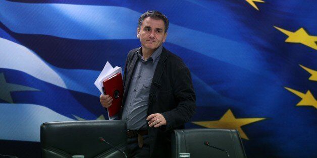 Greece's Finance Minister Euclid Tsakalotos arrives for a news conference in Athens on Tuesday, Nov. 17, 2015. Greece reached an agreement with European creditors Tuesday on economic measures it needs to introduce so it can get its next batch of bailout money, including a 10 billion-euro ($10.7 billion) cash injection for its crippled banks. (AP Photo/Petros Giannakouris)