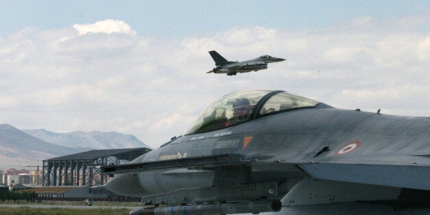 A Turkish F-16 prepares to taxi while another one takes off during Anatolian Eagle exercise at 3rd Main Jet Air Base near the central Anatolian city of Konya, Turkey, Monday, June 15, 2009. Dozens of U.S., British and Turkish pilots are engaging in mock aerial battles over central Turkey, indicating deepening relations between the allies. Pilots from Jordan and the United Arab Emirates are also participating in the exercise. (AP Photo/Selcan Hacaoglu)