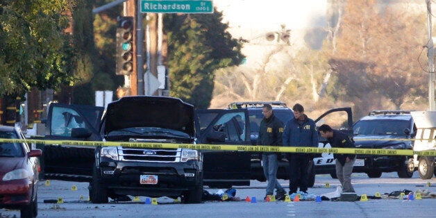 Authorities investigate the scene where a police shootout with suspects took place, Thursday, Dec. 3, 2015, in San Bernardino, Calif. A heavily armed man and woman opened fire Wednesday on a holiday banquet, killing multiple people and seriously wounding others in a precision assault, authorities said. Hours later, they died in a shootout with police. (AP Photo/Jae C. Hong)