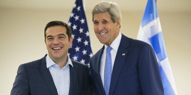 US Secretary of State John Kerry (R) and Greek Prime Minister Alexis Tsipras pose for the media at the United Nations headquarters in New York on September 30, 2015. AFP PHOTO/Dominick Reuter (Photo credit should read DOMINICK REUTER/AFP/Getty Images)