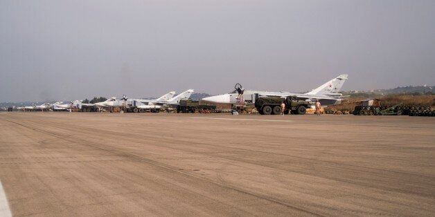 In this photo taken on Thursday, Oct. 22, 2015, Russian war planes are parked at Hemeimeem airbase, Syria. Nearly a quarter of a century after the Soviet collapse, the air campaign in Syria has proven that the resurgent Russian military machine could again operate far away from the nation's borders. (AP Photo/Vladimir Isachenkov)