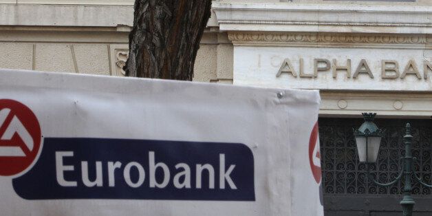 Alpha Bank and Eurobank logos are seen outside branches in Athens, Wednesday, March 14, 2012. Greece's Alpha Bank is to propose canceling a planned merger with Eurobank Ergasias due to the impact of the recent bond swap deal on the country's banks. The planned merger of Greece's second and third largest lenders, approved by shareholders last November, would have created the country's largest bank but Alpha said Wednesday it had informed Eurobank it would call a board meeting and propose ending the talks. (AP Photo/Thanassis Stavrakis)