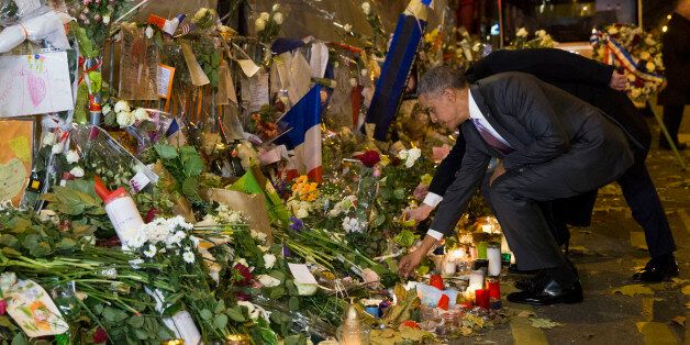 President Barack Obama places a flower at the Bataclan, a site of one of the Paris terrorists attacks, to pay his respects after arriving in town for the COP21 climate change conference Monday, Nov. 30, 2015, in Paris. (AP Photo/Evan Vucci)