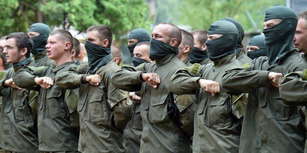 Recruits of the Azov far-right Ukrainian volunteer battalion take their oaths during a ceremony in Kiev, on August 14, 2015. Two people were killed in another round of intense shelling between Western-backed Ukrainian government's forces and pro-Russian fighters in the separatist east, officials from both sides said. Ukraine's military spokesman Andriy Lysenko said one soldier was killed and six wounded in the past 24 hours of fighting across the mostly Russian-speaking war zone. AFP PHOTO/ SERGEI SUPINSKY (Photo credit should read SERGEI SUPINSKY/AFP/Getty Images)