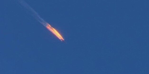 This frame grab from video by Haberturk TV, shows a Russian warplane on fire before crashing on a hill as seen from Hatay province, Turkey, Tuesday, Nov. 24, 2015. Turkey shot down the Russian warplane Tuesday, claiming it had violated Turkish airspace and ignored repeated warnings. Russia denied that the plane crossed the Syrian border into Turkish skies. (Haberturk TV via AP) TURKEY OUT