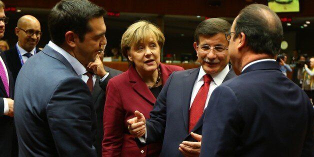 BRUSSELS, BELGIUM - NOVEMBER 29: Prime Minister of Greece Alexis Tsipras (L), Chancellor of Germany Angela Merkel (2nd L), Turkish Prime Minister Ahmet Davutoglu (2nd R) and President of France Francois Hollande (R) attend EU summit meeting in Brussels, Belgium on November 29, 2015. (Photo by Hakan Goktepe/Anadolu Agency/Getty Images)