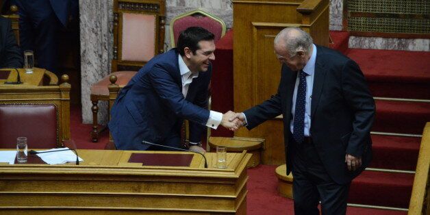 ATHENS, GREECE - 2015/10/07: Greek Prime Minister Alexis Tsipras (left) greets Vassilis Leventis (right) during the ' Vote for Confidence at Parliament' where 155 voted yes and 144 voted no, while only one legislator was absent. (Photo by George Panagakis/Pacific Press/LightRocket via Getty Images)