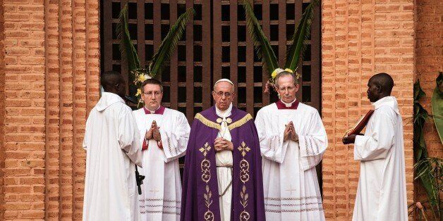 Pope Francis prays before the 'Holy Door' at Bangui Cathedral in the Central African Republic ahead of the start of a Catholic Jubilee Year, marking forgiveness and reconciliation on November 29, 2015. 'Open for us the gate of your mercy,' the 78-year-old pope prayed before opening the door. 'We ask for peace for Central African Republic and for all people who suffer from war.' AFP PHOTO/GIANLUIGI GUERCIA / AFP / GIANLUIGI GUERCIA (Photo credit should read GIANLUIGI GUERCIA/AFP/Getty Images)