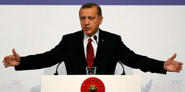Turkish President Recep Tayyip Erdogan gestures as he talks during a news conference at the end of the G-20 summit in Antalya, Turkey, Monday, Nov. 16, 2015. The leaders of the Group of 20 wrapped up their two-day summit near the Turkish Mediterranean coastal city of Antalya Monday against the backdrop of heavy French bombardment of the Islamic State's stronghold in Syria. The bombings marked a significant escalation of France's role in the fight against the extremist group. (Anadolu Agency via AP, Pool)