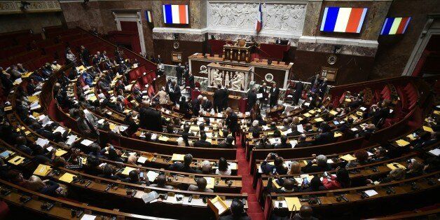 A picture taken on December 5, 2015 shows French flags on screens during a parliamentary meeting on the occasion of the United nations conference on climate change at the French National Assembly in Paris. / AFP / LIONEL BONAVENTURE (Photo credit should read LIONEL BONAVENTURE/AFP/Getty Images)