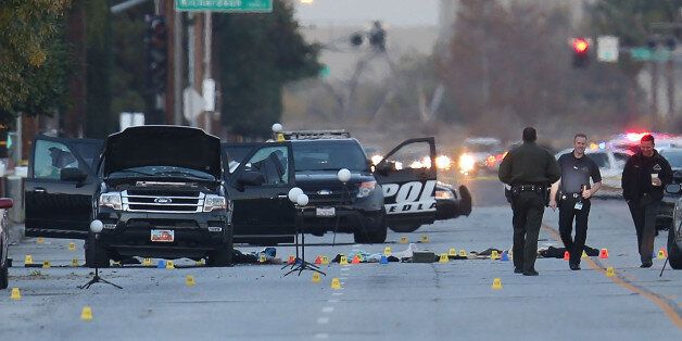 SAN BERNARDINO, CA - DECEMBER 04: Law enforcement officials continue their investigation around the Ford SUV vehicle that was the scene where suspects of the shooting at the Inland Regional Center were killed on December 4, 2015 in San Bernardino, California. Police continue to investigate a mass shooting at the Inland Regional Center in San Bernardino that left at least 14 people dead and another 17 injured on December 2nd. (Photo by Joe Raedle/Getty Images)