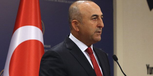 Turkish Foreign Minister Mevlut Cavusoglu speaks to the media in Ankara, Turkey, Saturday, July 25, 2015, about latest airstrikes against Islamic State group forces and Kurdish rebel bases. Turkish jets struck camps belonging to Kurdish militants in northern Iraq, authorities said Saturday, the first strike since a peace deal was announced in 2013, as Ankara also bombed Islamic State positions in Syria for a second straight night. (AP Photo/Burhan Ozbilici)
