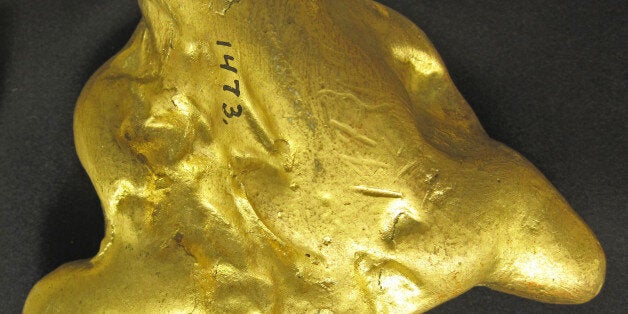 Replica of a large fluvial gold nugget (placer gold) ("Oregon Canyon Nugget") from California. (SDSMT 1473, South Dakota School of Mines and Technology Museum of Geology, Rapid City, South Dakota, USA)A mineral is a naturally-occurring, solid, inorganic, crystalline substance having a fairly definite chemical composition and having fairly definite physical properties. At its simplest, a mineral is a naturally-occurring solid chemical. Currently, there are over 4900 named and described minerals - about 200 of them are common and about 20 of them are very common. Mineral classification is based on anion chemistry. Major categories of minerals are: elements, sulfides, oxides, halides, carbonates, sulfates, phosphates, and silicates.Elements are fundamental substances of matter - matter that is composed of the same types of atoms. At present, 118 elements are known (four of them are still unnamed). Of these, 98 occur naturally on Earth (hydrogen to californium). Most of these occur in rocks & minerals, although some occur in very small, trace amounts. Only some elements occur in their native elemental state as minerals. To find a native element in nature, it must be relatively non-reactive and there must be some concentration process. Metallic, semimetallic (metalloid), and nonmetallic elements are known in their native state as minerals.Gold (Au) is the most prestigious metal known, but it's not the most valuable. Gold is the only metal that has a deep, rich, metallic yellow color. Almost all other metals are silvery-colored. Gold is very rare in crustal rocks - it averages about 5 ppb (parts per billion). Where gold has been concentrated, it occurs as wires, dendritic crystals, twisted sheets, octahedral crystals, and variably-shaped nuggets. It most commonly occurs in hydrothermal quartz veins, disseminated in some contact- & hydrothermal-metamorphic rocks, and in placer deposits. Placers are concentrations of heavy minerals in stream gravels or in cracks on bedrock-floored streams. Gold has a high specific gravity (about 19), so it easily accumulates in placer deposits. Its high density allows prospectors to readily collect placer gold by panning. In addition to its high density, gold has a high melting point (over 1000º C). Gold is also relatively soft - about 2.5 to 3 on the Mohs Hardness Scale. The use of pure gold or high-purity gold in jewelry is not desirable as it easily gets scratched. The addition of other metals to gold to increase the hardness also alters the unique color of gold. Gold jewelry made & sold in America doesnât have the gorgeous rich color of high-purity gold.The specimen shown above is a replica of a large gold nugget.Locality: El Dorado County, California, USA