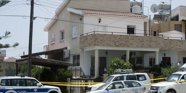 Cypriot police cordon off the house of a Lebanese man holding a Canadian passport in the Cypriot coastal city of Larnaca where more than 400 boxes of ammonium nitrate -- a fertiliser that when mixed with other substances can be used to make explosives -- was discovered, on May 28, 2015. The suspected was remanded in Cypriot police custody after two tonnes of the potential bomb-making material was found in his home, police said. They said the man, 26, whose name was not disclosed, appeared in court in the southern resort town of Larnaca for a hearing held behind closed doors 'in the interests of national security'. AFP PHOTO / IAKOVOS HATZISTAVROU (Photo credit should read IAKOVOS HATZISTAVROU/AFP/Getty Images)