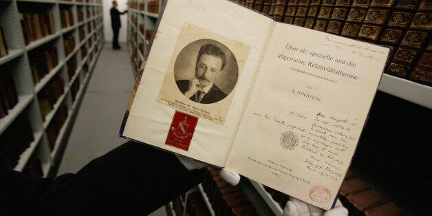 SWINDON, UNITED KINGDOM - MARCH 11: In this photo illustration, Head Site Librarian Nick Wyatt (unseen) holds a signed copy of On Special and General Relativity Theory (popularisation) by Albert Einstein at the Science Museum Library and Archives on March 11, 2008 in Swindon, England. The new facilities recently opened to the public after significant parts of the Science Museum's international archive, which includes works of Newton, Einstein, Darwin and Flamel, were moved from London to Swindon. (Photo by Daniel Berehulak/Getty Images)