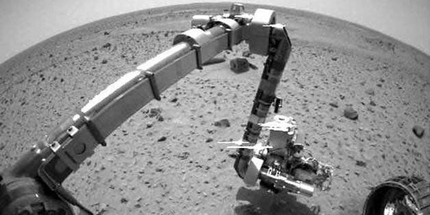 Mars, SPACE: TO GO WITH AFP STORY IN FRENCH : 'VINGT ANS APRES CHALLENGER, LES ROBOTS FONT LA UNE DE L'EXPLORATION SPATIALE' - (FILES) -This photo released by NASA/JPL and the US Geological Survey 16 January, 2004, shows the Mars explorer Spirit Spirit reaching out with its robot arm to meet up with the martian soil for the first time. Its Microscopic Imager, one of four instruments at the end of the rover's arm, took the highest resolution image of the martian surface to date. Throughout the mission, this instrument will act as a geologist's hand lens, providing close up views of rocks and soils. AFP PHOTO/NASA/JPL/US Geological Survey (Photo credit should read -/AFP/Getty Images)