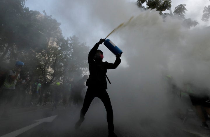 An anti-government protester uses a fire extinguisher during a march in Tuen Mun, Hong Kong on Sept. 21, 2019.