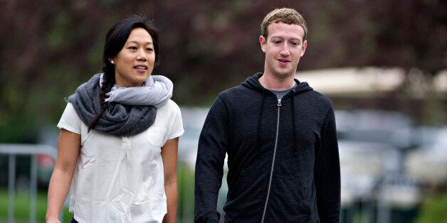 Mark Zuckerberg, chief executive officer and founder of Facebook Inc., walks with his wife Priscilla Chan while arriving for a morning session during the Allen & Co. Media and Technology Conference in Sun Valley, Idaho, U.S., on Thursday, July 11, 2013. Executives from media, finance and politics mingle at the mountain resort between presentations on business trends and social issues, brought together by New York investment banker Herb Allen. Photographer: Daniel Acker/Bloomberg via Getty Images