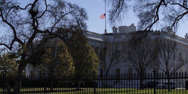 WASHINGTON, USA - DECEMBER 3: The American flag flys at half-staff above the White House December 3, 2015 in Washington, DC. after U.S. President Barack Obama signed a proclaimation ordering all flags to be flown at half-staff to honor the victims of Wednesday's mass shooting in San Bernardino, California. (Photo by Samuel Corum/Anadolu Agency/Getty Images)